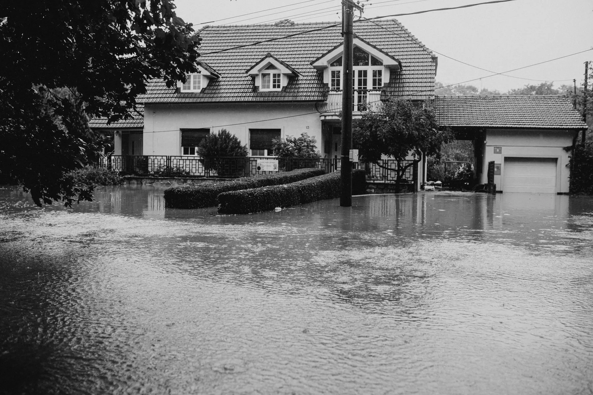 Standing water on a basement floor near a sump pit