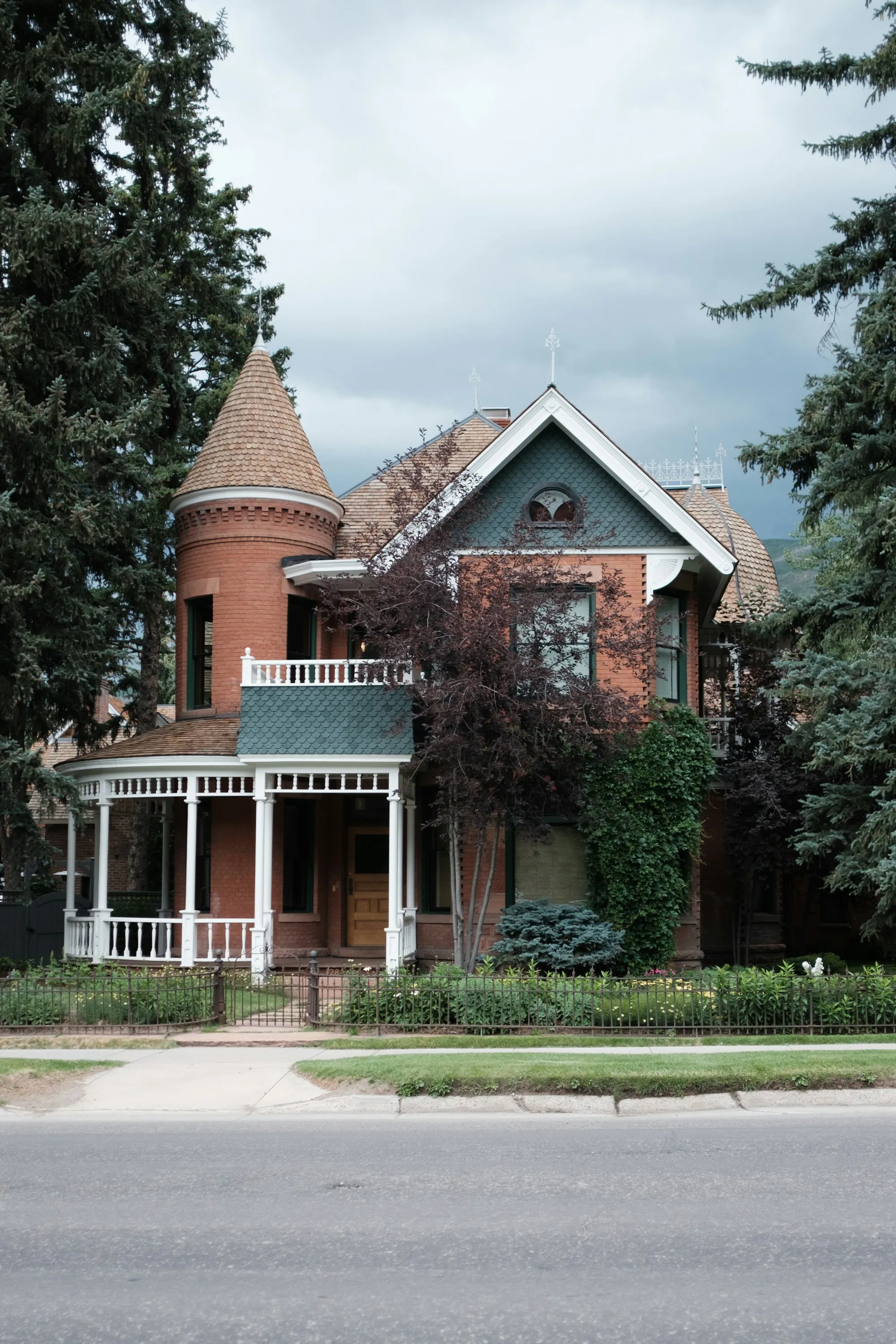 Victorian-era brick home on a tree-lined small-town street